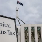 Capital gains tax sign in front of an Australian government building, reflecting housing tax reform and supply policy debate.