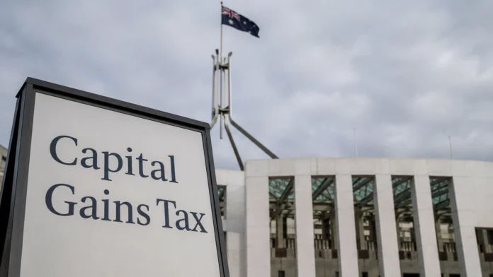 Capital gains tax sign in front of an Australian government building, reflecting housing tax reform and supply policy debate.