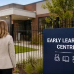 Two business professionals stand outside a modern early learning centre, reflecting tighter childcare property lending and lender scrutiny of commercial assets.