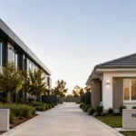 Commercial office building and residential home side by side, showing the choice between commercial and residential property investing.