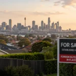 For sale sign outside an established Australian home with Sydney skyline in the background, representing the foreign buyer ban and housing affordability debate.