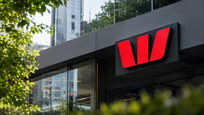 Westpac-style bank branch signage on a modern glass building, framed by greenery in an Australian city setting. 