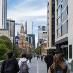 Students walk past purpose-built student accommodation near a university campus in an Australian city centre