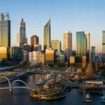 Alt text: Perth city skyline at golden hour with the Swan River and waterfront precinct in the foreground, illustrating the strength and moderation of the Perth property market.