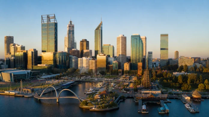 Alt text: Perth city skyline at golden hour with the Swan River and waterfront precinct in the foreground, illustrating the strength and moderation of the Perth property market.