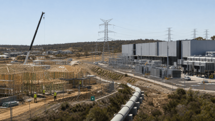 New housing construction beside a large Australian data centre competing for electricity and infrastructure.